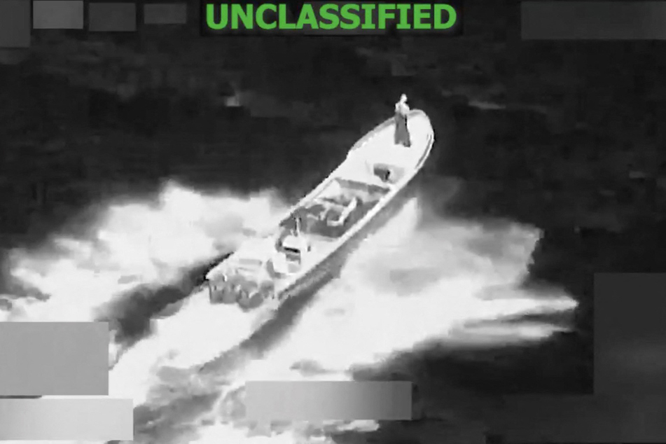 This screen grab from a video posted on the X account of US Southern Command (SOUTHCOM) on Monday shows a strike at the direction of Defense Secretary Pete Hegseth on a vessel alleged to be transiting along narco-traficking routes on Monday in "international waters."