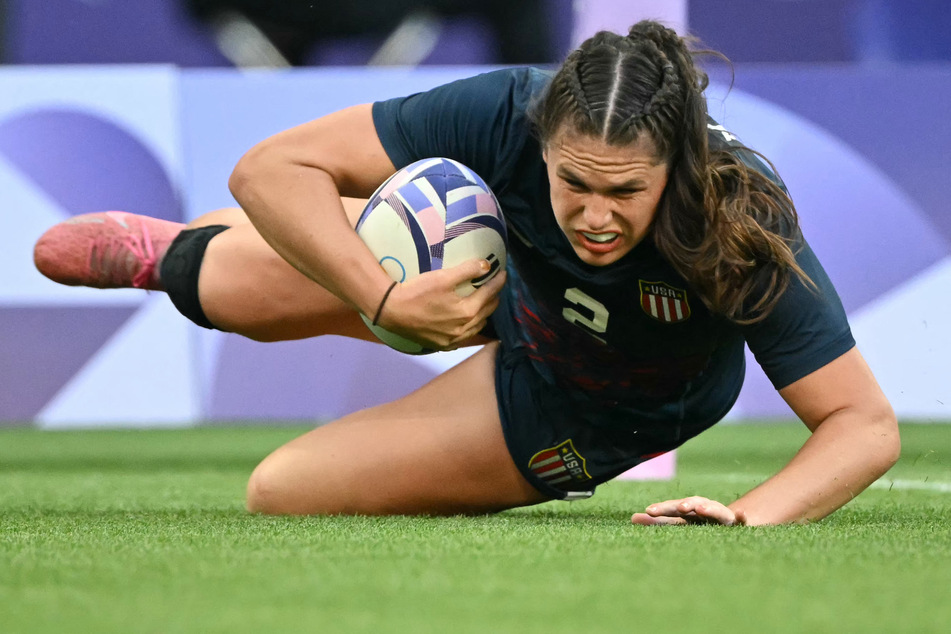 US' Ilona Maher scores a try during the women's pool C rugby sevens match between the USA and Brazil during the Paris 2024 Olympic Games at the Stade de France in Saint-Denis on Sunday, July 28, 2024.