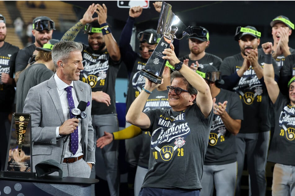 Milwaukee Brewers owner Mark Attanasio is presented with the Warren C. Giles Trophy after his team wins the National League Championship Series on October 15. The Brewers led the MLB this season with 103 wins – a record for the team.