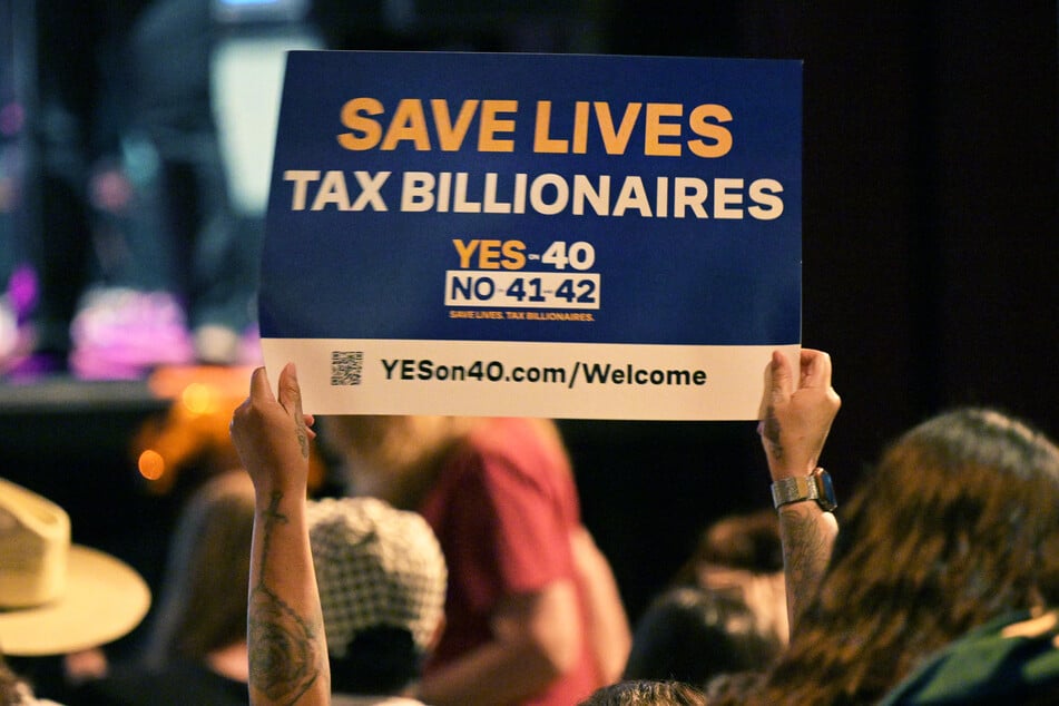 A supporter of Proposition 40 holds up a sign during a California wealth tax rally in Los Angeles on October 5, 2026.