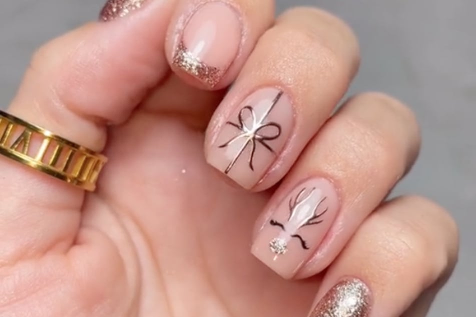 For anyone looking to have one design for both Christmas and New Years, TikToker @nails.by.iz's look is very simple, chic, and universal.