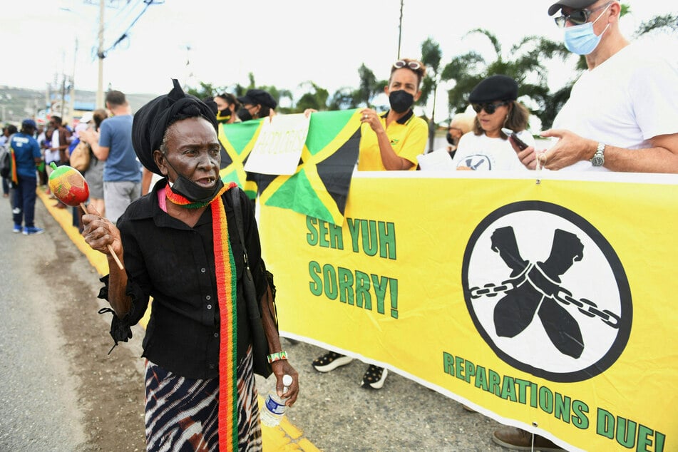 People call for reparations for slavery in a protest outside the British High Commission in Kingston, Jamaica, on March 22, 2022, during a visit by the UK's Prince William and Princess Catherine.