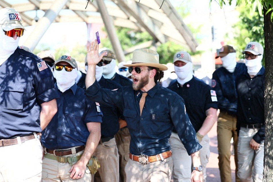 Patriot Front founder Thomas Rousseau (c) and fellow members gather at Eastern Market metro station on July 4, 2026, in Washington, DC.
