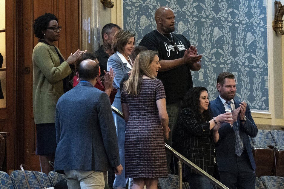 House Speaker Nancy Pelosi, Sandra Garza, Gladys Sicknick, and Officers Harry Dunn and Michael Fanone clap after hearing the vote count for establishing a select committee to investigate the January 6 Capitol attack.