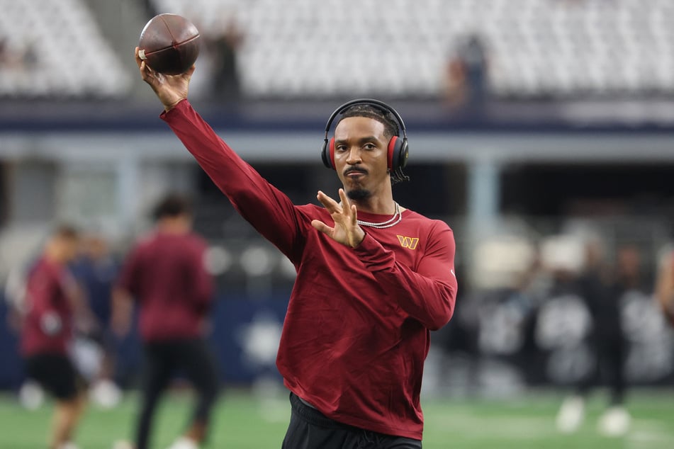 Jayden Daniels of the Washington Commanders warms up before a game against the Dallas Cowboys at AT&T Stadium on September 20, 2026. There is no timeline for the quarterback's return after he was injured during the game.