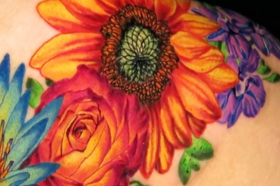 A close-up shot of Cardi B's botanical back piece by Jamie Schene.