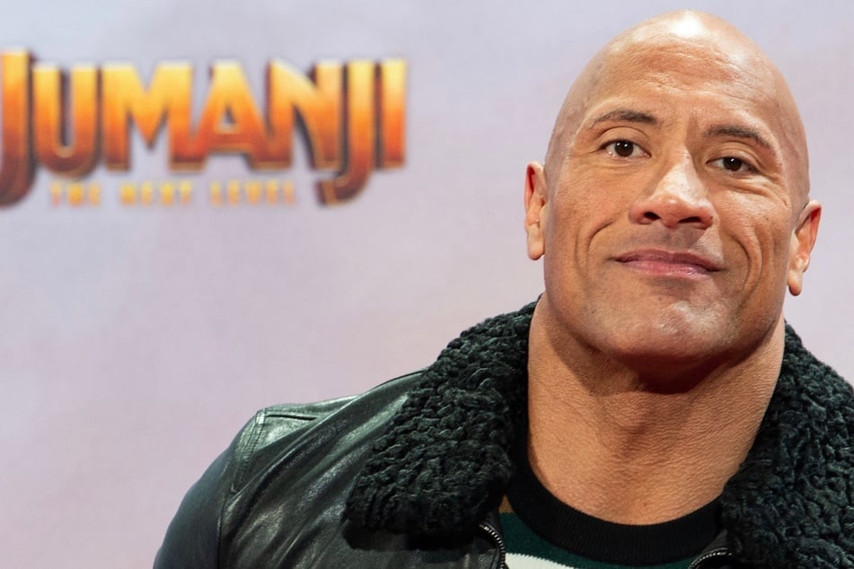 The Rock hulks out on his locked front gate so he can get to work on time