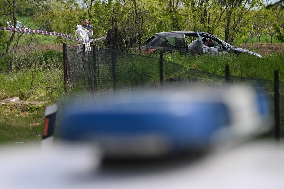 Forensic investigator works at one of the crime scenes following the second mass shooting in Serbia in days.