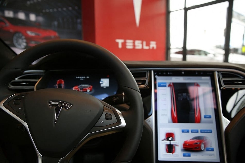 The inside of a Tesla vehicle is shown as it sits parked in a new showroom and service center in New York City.