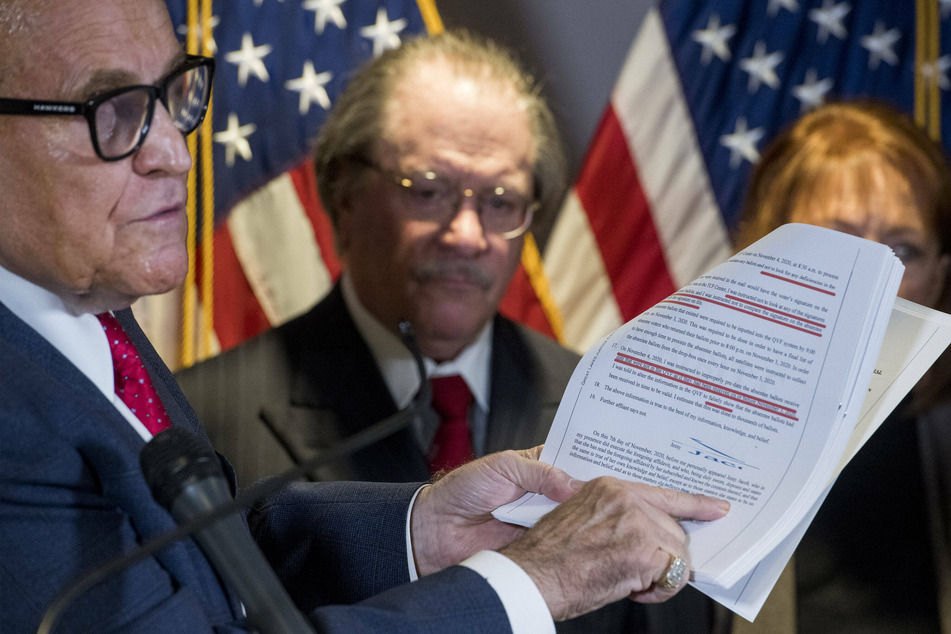 The Trump campaign, led by Rudy Giuliani (l.), continues to insist that the election was marred by fraud.