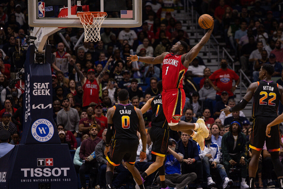 New Orleans Pelicans forward Zion Williamson dunks the ball against Phoenix Suns guard Devin Booker and forward Torrey Craig during the second half at Smoothie King Center.