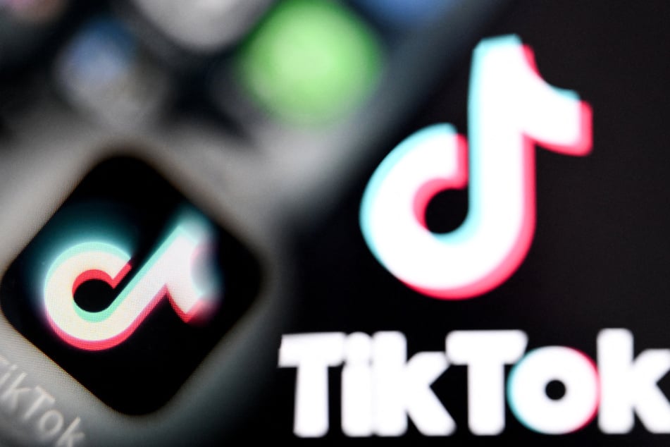 A photo taken on April 10, 2025 shows TikTok's logos on a smartphone screen. The popular video-sharing app will face its first US trial on Monday.