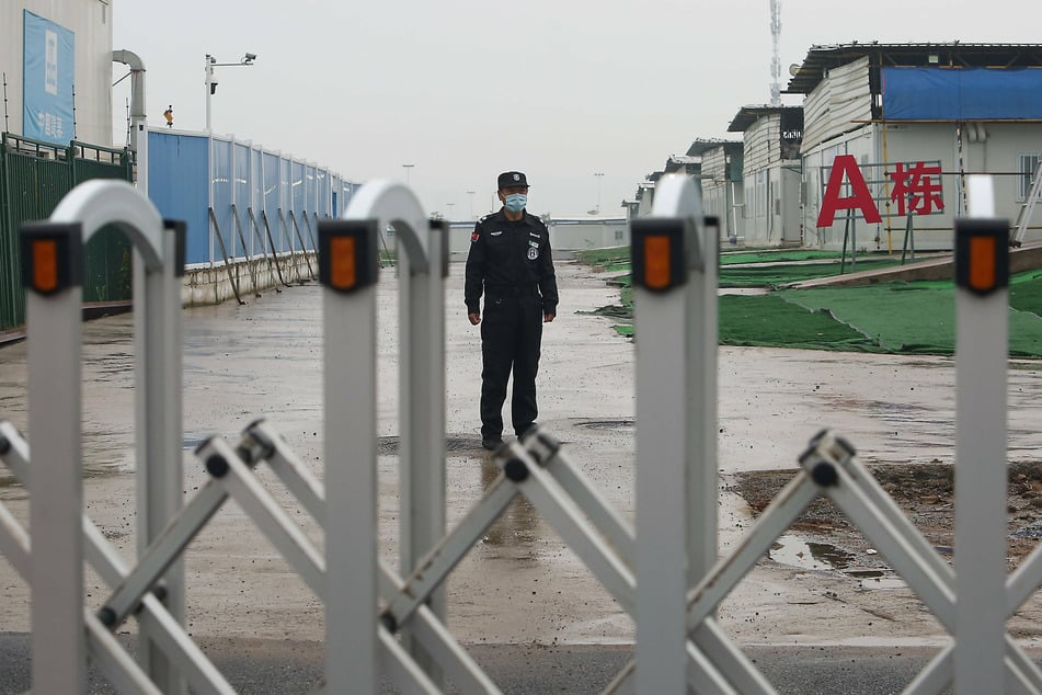Security guard is posted at a gate sealing off the temporary Leishengshan hospital built in ten days to treat coronavirus patients in Wuhan.