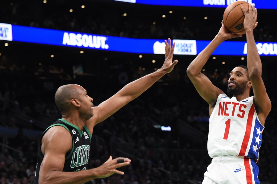 Brooklyn Nets forward Mikal Bridges (r.) shoots over Boston Celtics center Al Horford during Friday's game at Boston.