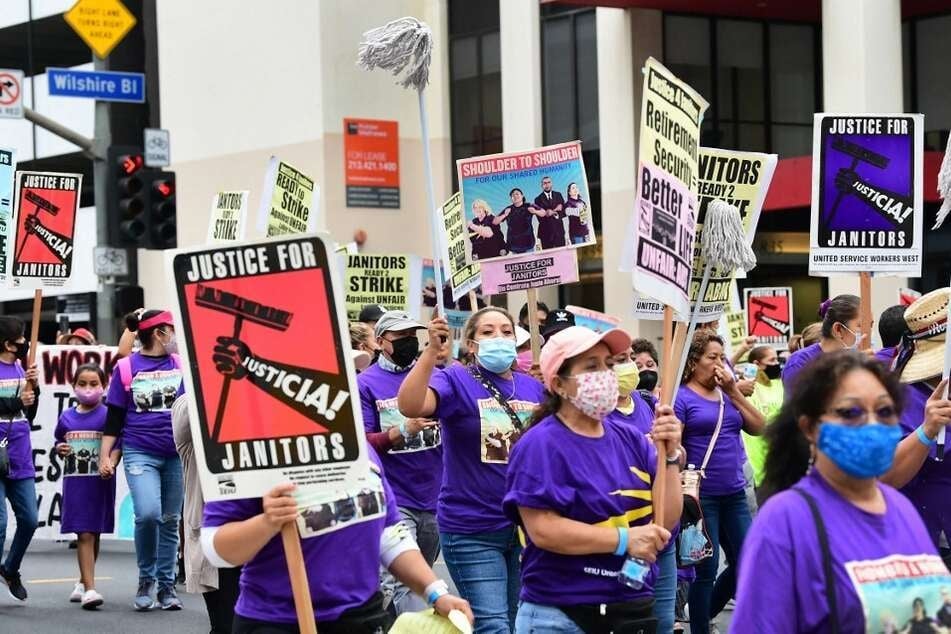 More than 1,000 janitors with the Service Employees International Union rally and march in Los Angeles.
