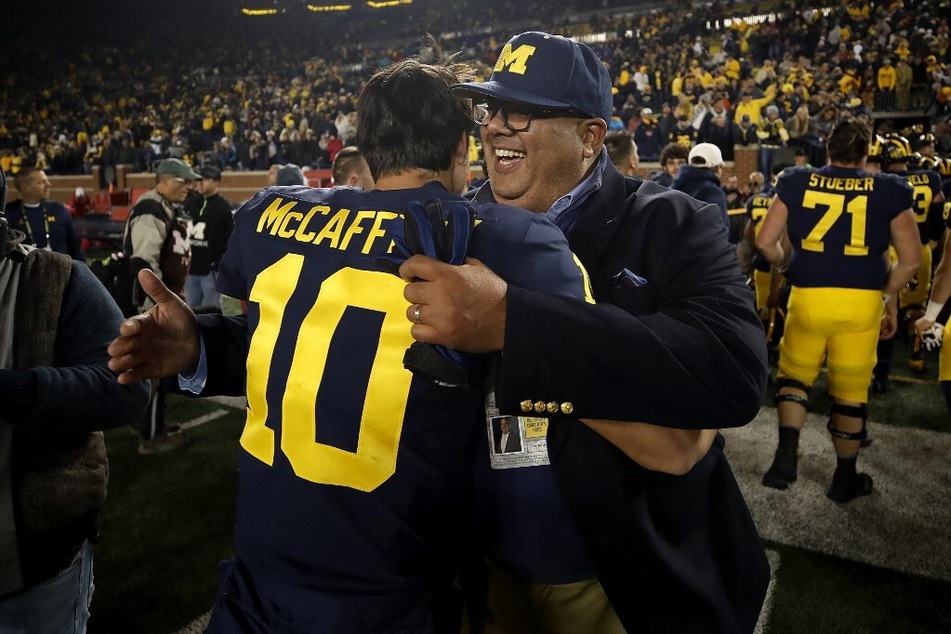 Michigan athletic director Warde Manuel (r.) has become a trending topic over alleged issues within the athletic department.