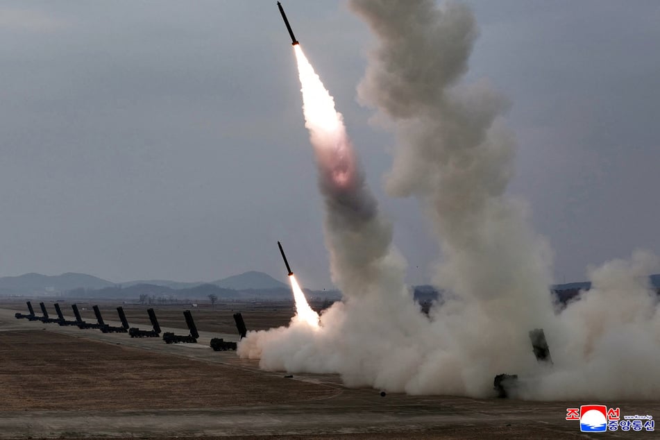 North Korean state media publish images of ballistic missiles being fired during a test that also featured a nuclear-capable launcher.