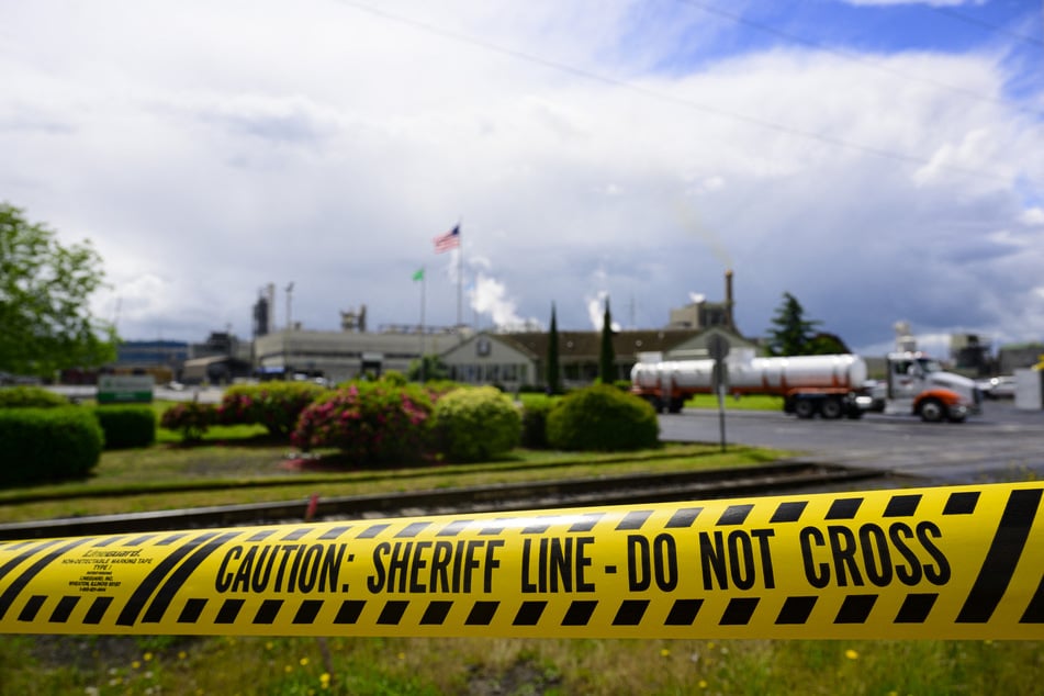 Emergency tape is pictured in front of the Nippon Dynawave Packaging facility following a fatal chemical storage tank implosion.