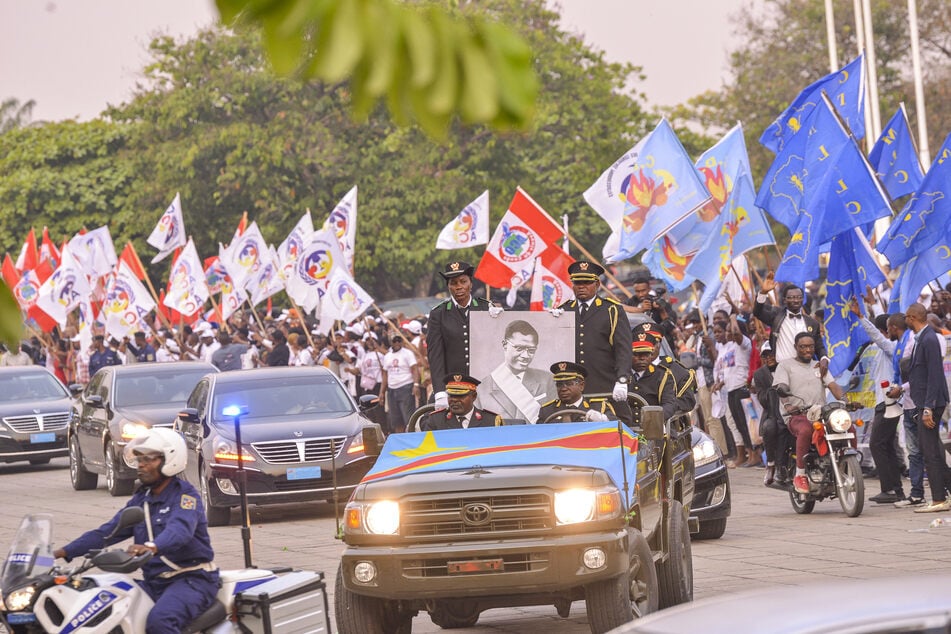 The cortege carrying Congolese independence hero Patrice Lumumba's only surviving remains arrives at Palais du Peuple in Kinshasa on June 27, 2022.