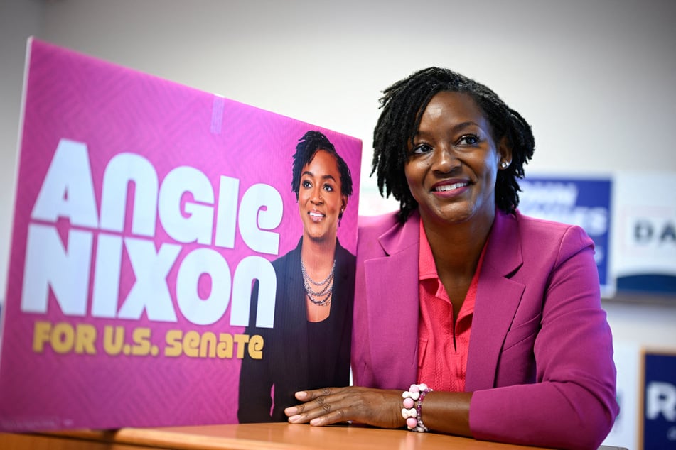 Angie Nixon poses for a photo alongside a campaign poster in Orlando, Florida, on September 5, 2026. The Democratic nominee has made tackling the US affordability crisis central to her bid for Senate.