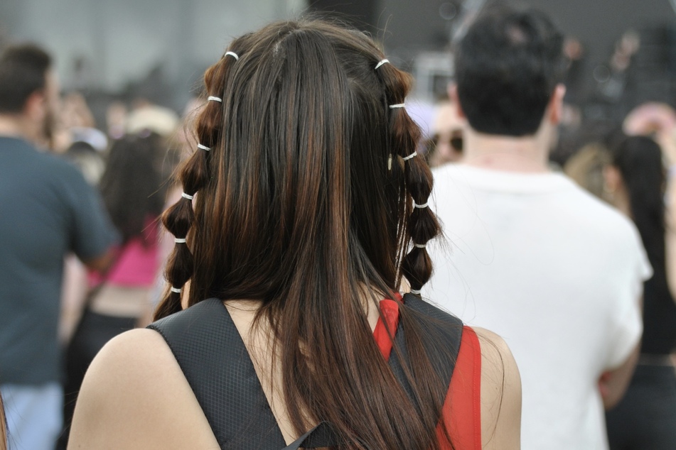 A festivalgoer with a trendy bubble hairstyle listens to Diplo at Day 1 at Governors Ball Music Festival on Friday, June 9, 2023.