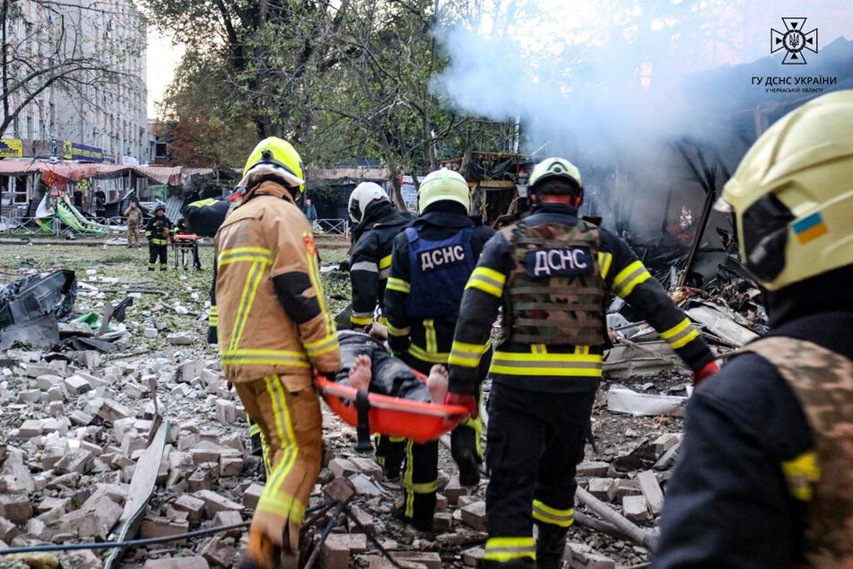 Emergency personnel work next to a damaged building in the aftermath of a Russian military strike in Cherkasy, Ukraine, on September 21, 2023.