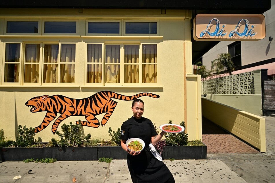 Chef Tue Nguyen displays her Di Di Fried Rice and Beef Carpaccio outside her West Hollywood restaurant, Di Di.