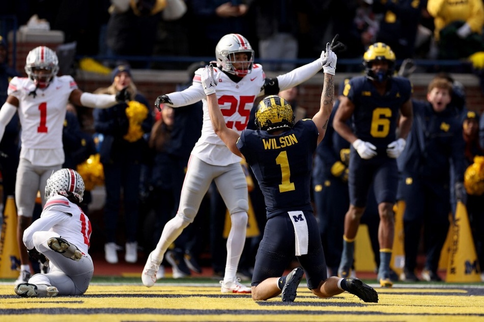 The Ohio State-Michigan showdown is buzzing with controversy after a Michigan touchdown sparked debate over whether it should have been ruled a Buckeye interception.