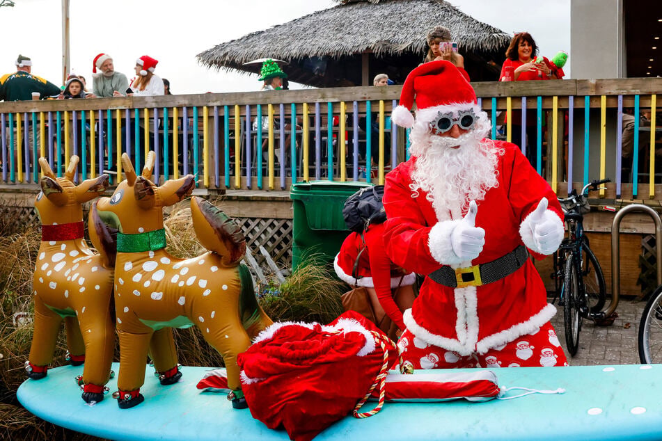 Surfing Santas descend on Florida beach for a heartwarming cause