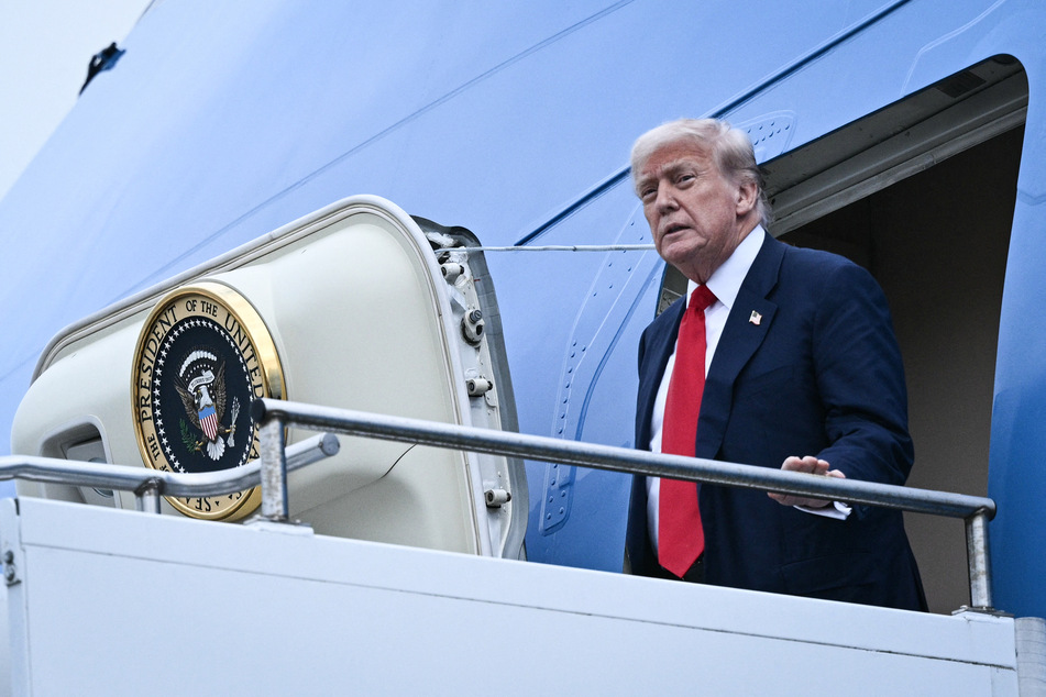 President Donald Trump disembarks from Air Force One upon his arrival at Prestwick Airport, south of Glasgow, on the first day of his UK visit.