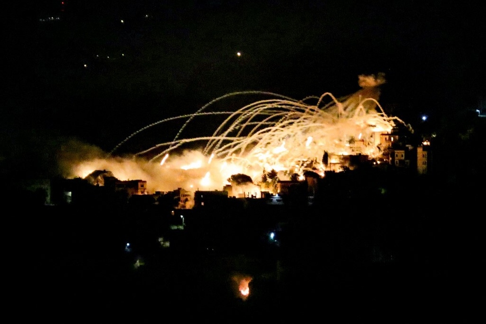 A picture taken from the area of Marjeyoun in southern Lebanon shows the sky lit up by an explosion over the town of Khiam during Israeli bombardment on October 31, 2024.
