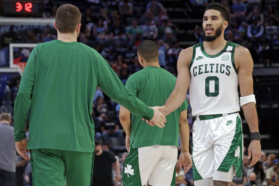 Jayson Tatum (r.) grabbed 31 points as the Celtics sealed second seed with a win over the Grizzlies.