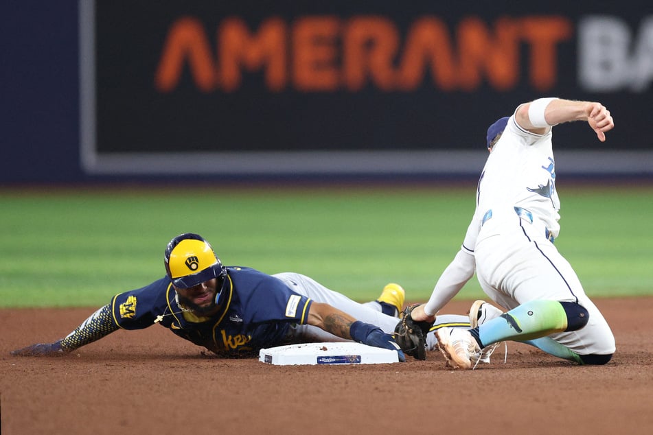 Milwaukee Brewers outfielder Jackson Chourio steals second base against Tampa Bay Rays shortstop Taylor Walls during the fifth inning in game three of the 2026 World Series.