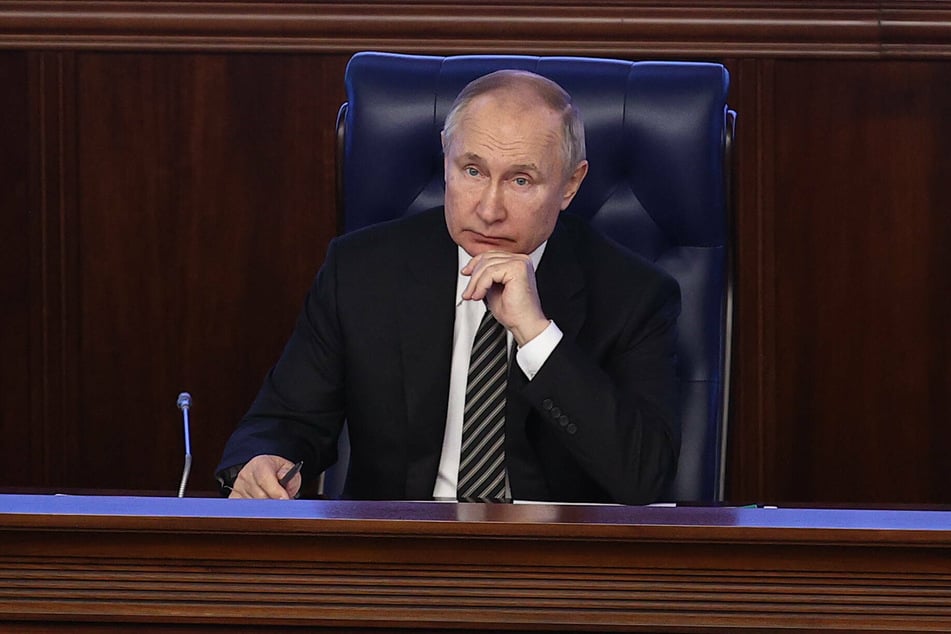 Russian President Vladimir Putin attends an extended meeting of the Russian Defense Ministry Board at the National Defense Control Center.