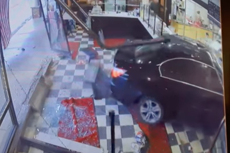 Braking bad: footage shows woman crashing her car into NYC bakery