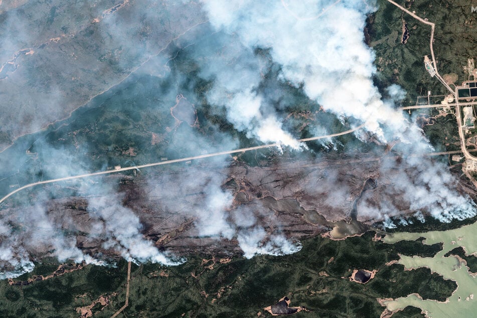 This handout satellite picture, courtesy of Maxar Technologies, shows an overview of York Factory First Nation wildfire in Illford, Manitoba, Canada on May 30, 2025.