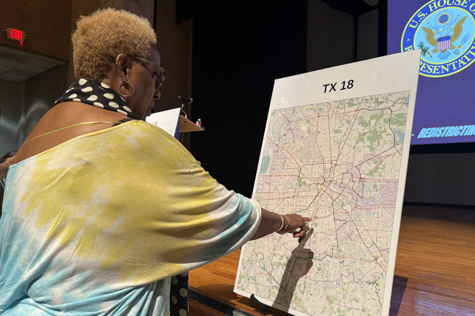 A voter looks at a map to understand the new redistricting lines approved by Republican lawmakers for the 2026 midterm elections, at San Jacinto College in Houston, Texas, on August 27, 2025.