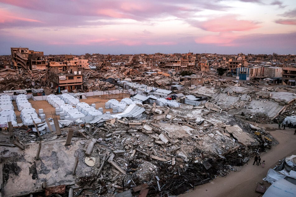 Tents sheltering displaced Palestinians are pictured between the rubble of destroyed buildings in the Jabalia refugee camp in the northern Gaza Strip on October 20, 2026.