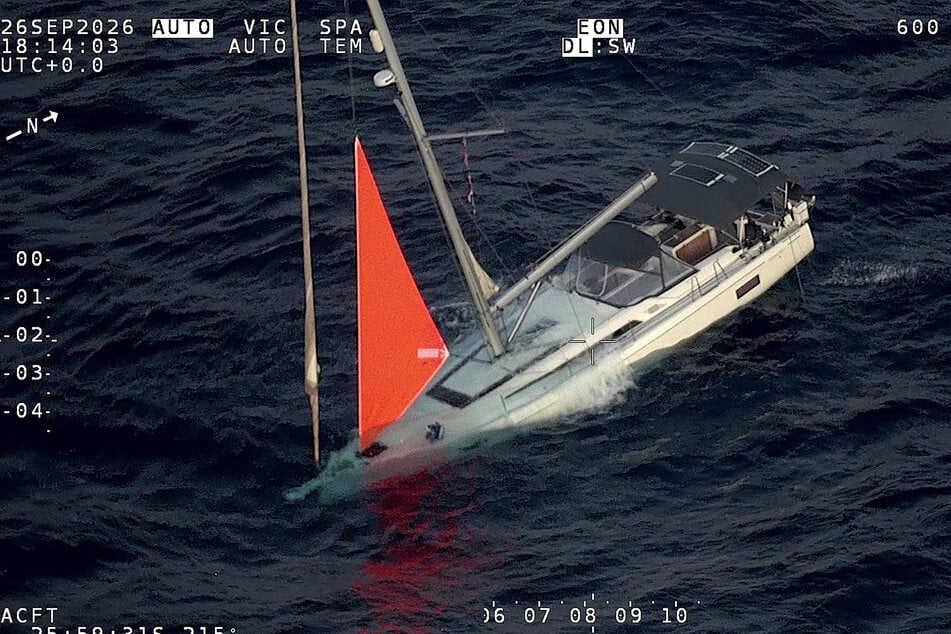 This handout image taken on September 26 shows a yacht sinking after a sperm whale struck and cracked the hull in the remote South Pacific. The accident left sailors in a fight for survival.