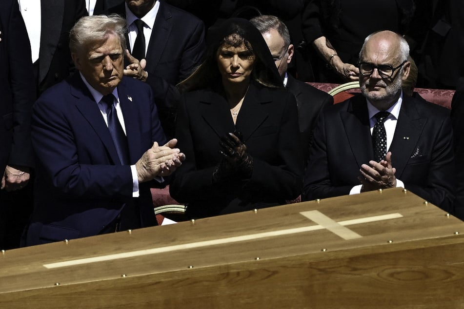 President Donald Trump (l.) and first lady Melania Trump (c.) attend the funeral mass of Pope Francis in St. Peter's Square at the Vatican.