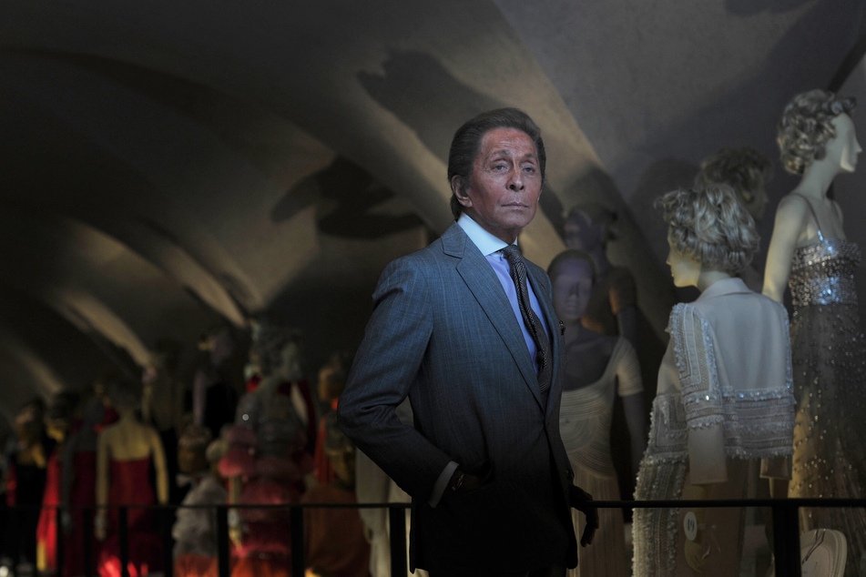 Italian couturier Valentino Garavani poses for photographs at the launch of his exhibition "Valentino: Master of Couture" at Somerset House in central London on November 28, 2012.