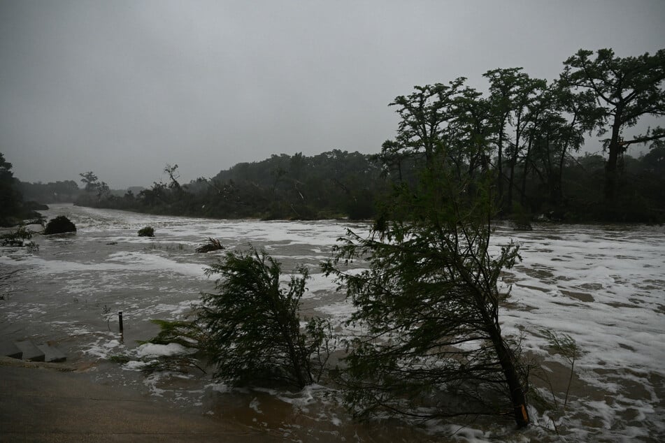 Rescuers were desperately searching for at least 20 girls missing from a riverside summer camp, officials said Friday, after torrential rains caused a "catastrophic" flash flood that killed at least 24 people.