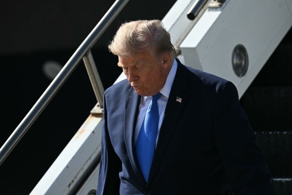 President Donald Trump steps off Air Force One upon arrival at Los Angeles International Airport in Los Angeles on Tuesday.