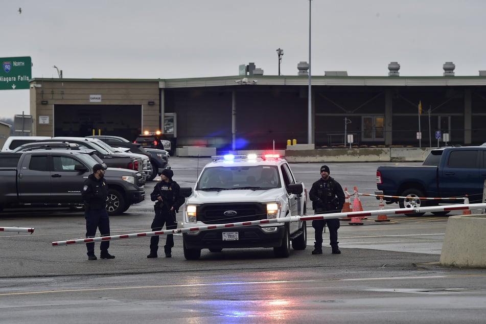Police stand guard at Peace Bridge after a car crashed and exploded at The Rainbow Bridge on Wednesday in Niagara Falls, New York.