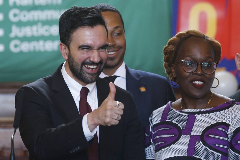 New York City Mayor Zohran Mamdani (l.) gives a thumbs-up next to newly appointed Chief Equity Officer Afua Atta-Mensah at the conclusion of a press conference in East Harlem on January 15, 2026.