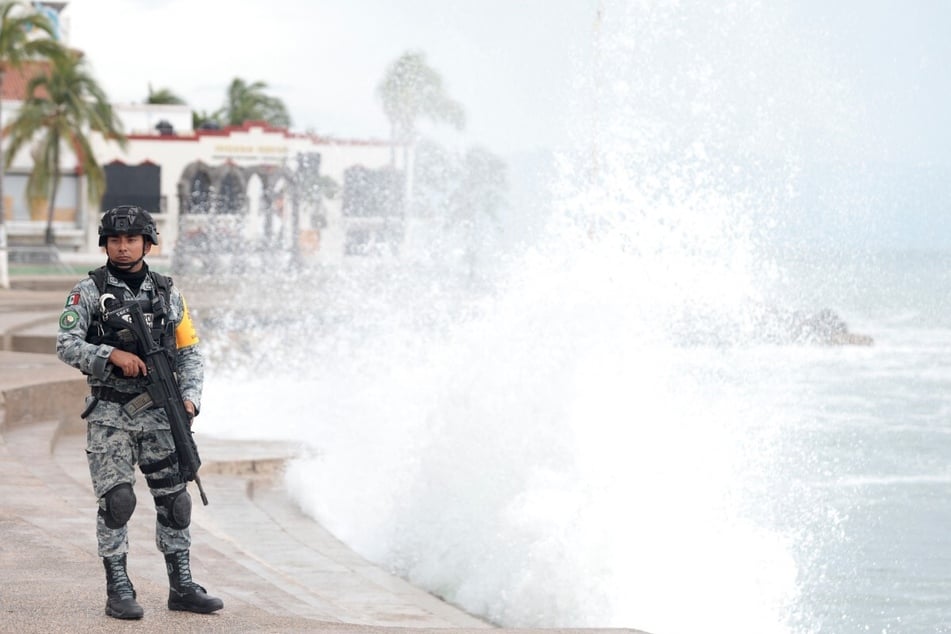 The waterfront in Puerto Vallarta, Mexico, is being guarded by Mexico's National Guard as Hurricane Simon continues to slowly churn off the coast.
