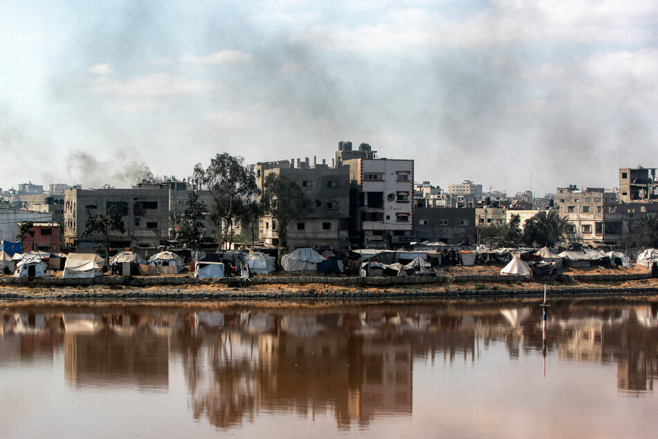 Encampments sheltering displaced Palestinians are pitched near the Sheikh Radwan wastewater collection pond, which is nearing its filling capacity, in Gaza City on July 14, 2025.