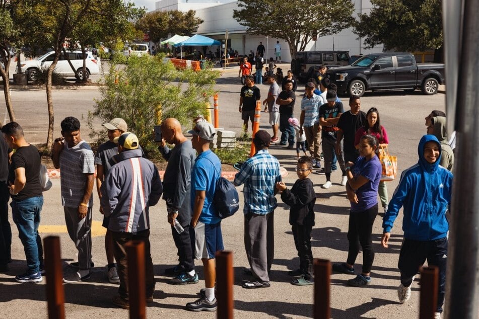 Groups of migrants wait to receive food outside the Migrant Resource Center in San Antonio, Texas, where the flights were boarded to Martha's Vineyard.