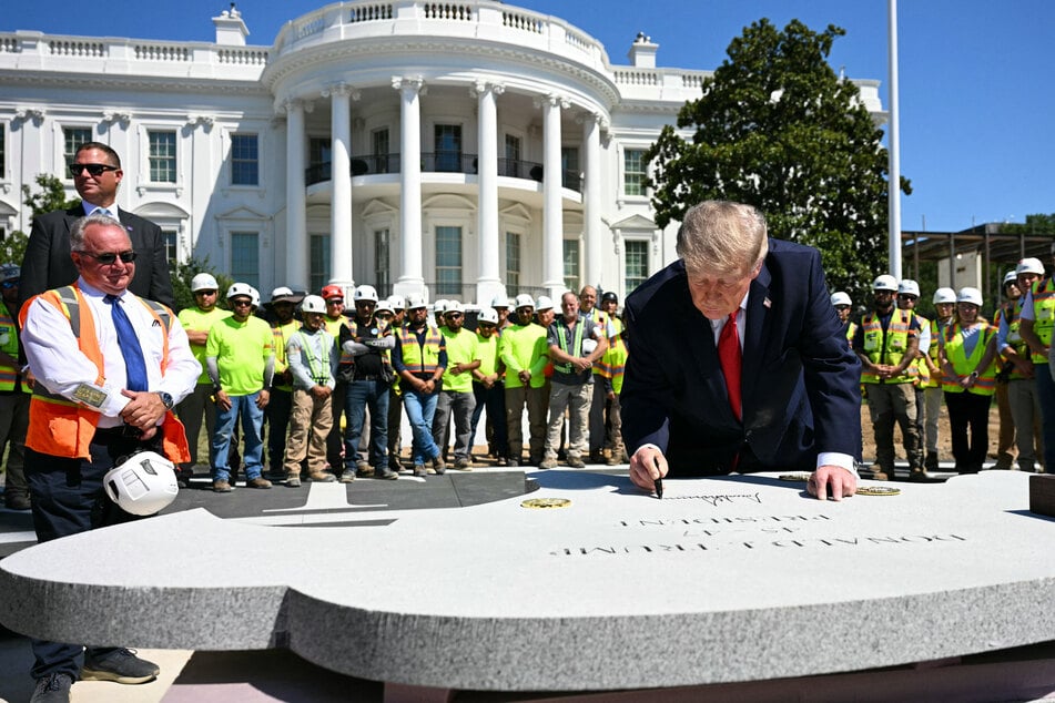 Trump signed the back of a stone shaped like an eagle's head that will be placed into the new helipad.