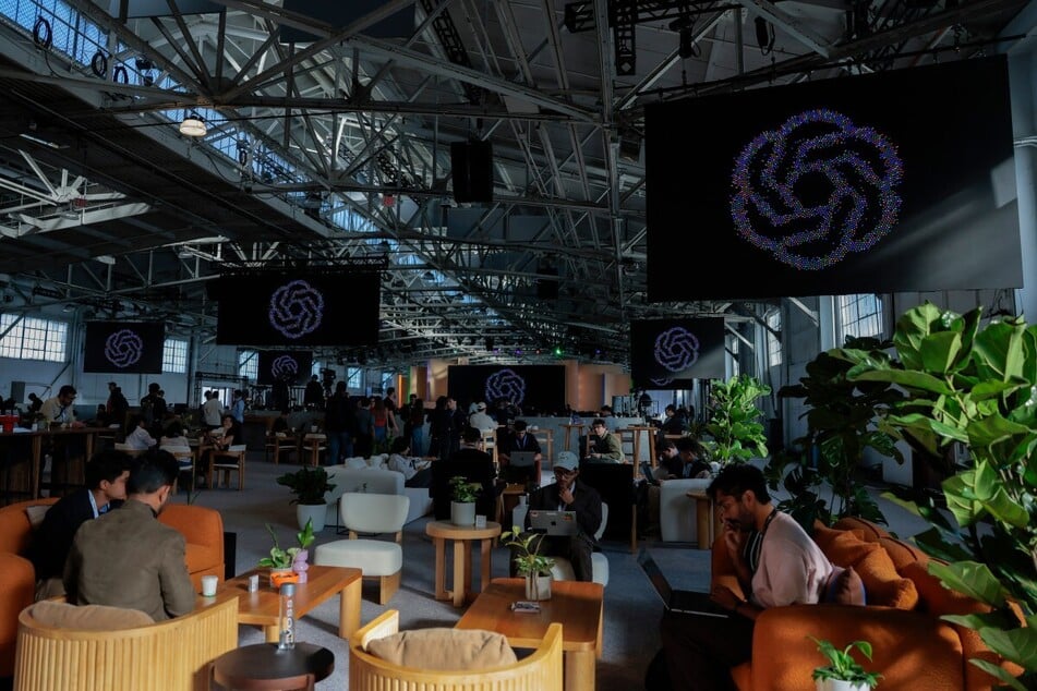 Attendees arrive for an OpenAI developers conference in California. A former OpenAI developer was ordered to be held without bail after a US judge deemed him a flight risk.